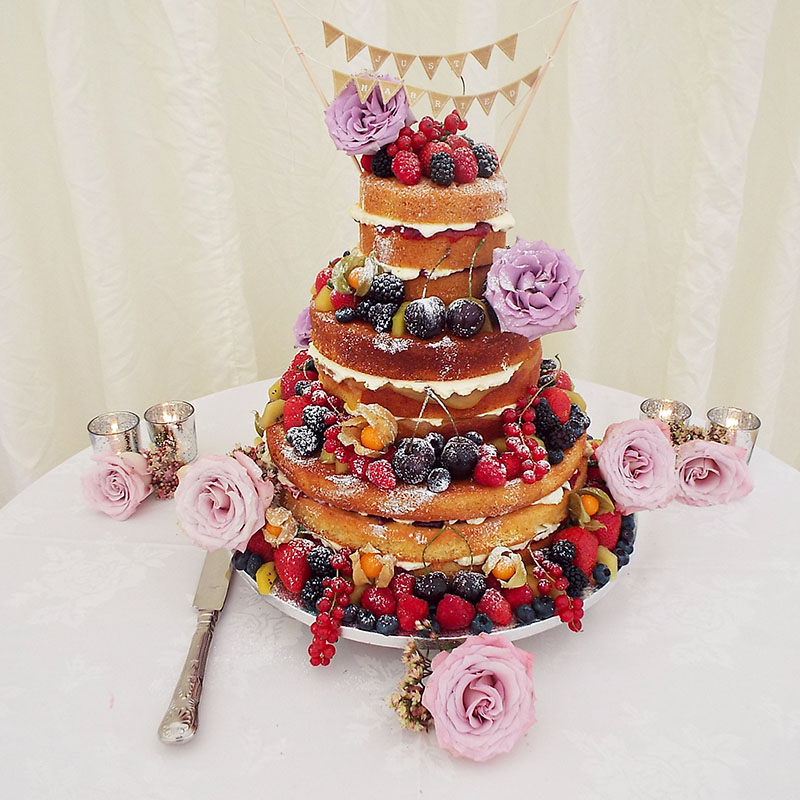 naked 3tier wedding cake with bunting and roses